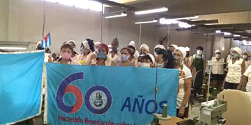 Por el aporte de sus mujeres a la confección de nasobucos y de uniformes para Educación y la Defensa, el taller textil 114 en Artemisa exhibe la bandera Aniversario 60 de la FMC